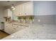 Bright kitchen featuring sleek countertops, modern backsplash, and white cabinetry at 1610 Ford St, Charlotte, NC 28216