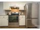 Modern kitchen with stainless steel appliances, white cabinets, and neutral countertops at 1610 Ford St, Charlotte, NC 28216