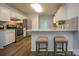 Kitchen features stainless steel appliances, a breakfast bar with seating, and hardwood floors at 1610 Ford St, Charlotte, NC 28216
