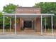 Exterior view of Oakdale Elementary School featuring a covered entrance, brick facade, and well-maintained landscaping at 1610 Ford St, Charlotte, NC 28216