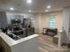 Updated kitchen features stainless steel appliances, gray cabinets, and a dining area with natural light at 1623 Flagler Ln, Charlotte, NC 28216