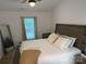 Bright bedroom with a wooden bed frame, comfortable bedding, and natural light from the window at 1623 Flagler Ln, Charlotte, NC 28216