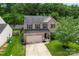 An aerial view of a well-kept two-story house with a front lawn and tree-lined backyard at 16615 Crimson Sargent Dr, Charlotte, NC 28213