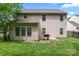 A large backyard with a lush green lawn, a black fence, and a grill on a concrete patio at 16615 Crimson Sargent Dr, Charlotte, NC 28213