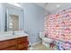 Bright bathroom with a colorful shower curtain, vanity, and light blue walls at 16615 Crimson Sargent Dr, Charlotte, NC 28213