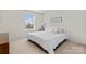 Bright bedroom featuring a window with blinds, and a bed with white bedding and decor at 16615 Crimson Sargent Dr, Charlotte, NC 28213