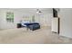Bright bedroom with three windows, neutral carpet, ceiling fan, bed, and decorative wall art at 16615 Crimson Sargent Dr, Charlotte, NC 28213