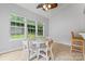 Sunlit breakfast nook features white table and chairs, complemented by the natural light from windows at 16615 Crimson Sargent Dr, Charlotte, NC 28213