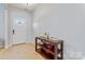 Bright foyer with tile flooring and a wooden console table, creating a welcoming entrance at 16615 Crimson Sargent Dr, Charlotte, NC 28213