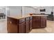 Spacious kitchen island with rich wood cabinetry, granite countertop and stylish hardware at 16615 Crimson Sargent Dr, Charlotte, NC 28213