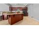 Kitchen features an island with granite countertops, dark wood cabinets, and stainless steel appliances at 16615 Crimson Sargent Dr, Charlotte, NC 28213