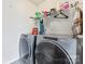 Efficient laundry room with modern washer and dryer, maximizing space with shelving at 16615 Crimson Sargent Dr, Charlotte, NC 28213