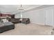 Open concept living room with cozy grey sectional, complemented by a modern chandelier at 16615 Crimson Sargent Dr, Charlotte, NC 28213