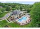 Aerial view of a community clubhouse with a pool and outdoor seating areas at 16615 Crimson Sargent Dr, Charlotte, NC 28213