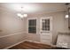Well lit dining room with luxury vinyl plank flooring, crown molding, and modern lighting at 1708 Dogwood Ln, Lancaster, SC 29720