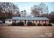 Charming brick ranch home with manicured bushes, dark shutters and a spacious front yard at 1708 Dogwood Ln, Lancaster, SC 29720