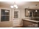 Well lit kitchen with granite countertops, neutral colored cabinets and a door to the exterior at 1708 Dogwood Ln, Lancaster, SC 29720