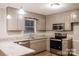 Well-lit kitchen features stainless appliances, gray cabinetry, and granite countertops at 1708 Dogwood Ln, Lancaster, SC 29720