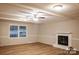 Living room featuring a fireplace, ceiling fan, and luxury vinyl plank flooring at 1708 Dogwood Ln, Lancaster, SC 29720