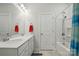 Bright bathroom featuring a double vanity with white countertop, a tub with a shower, and stylish mirrors at 1825 Lotus Ln, Denver, NC 28037