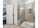Modern bathroom with a tiled shower, a built-in seat, and a view into the bedroom at 1825 Lotus Ln, Denver, NC 28037