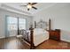 Tranquil bedroom with a decorative metal bed frame, a ceiling fan, and natural light from the window at 1825 Lotus Ln, Denver, NC 28037