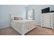 Cozy bedroom with a comfortable bed, white dresser, and window providing natural light at 1825 Lotus Ln, Denver, NC 28037