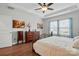 Comfortable bedroom with a decorative headboard bed, matching dressers, and soft, natural lighting at 1825 Lotus Ln, Denver, NC 28037