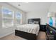 Cozy bedroom features a neutral paint and a bed with simple decor at 1825 Lotus Ln, Denver, NC 28037