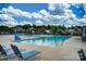 Outdoor community pool features lounge chairs, umbrellas, and clear blue skies at 1825 Lotus Ln, Denver, NC 28037