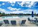 Outdoor community pool features lounge chairs, umbrellas, and a barbecue area at 1825 Lotus Ln, Denver, NC 28037