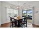 Cozy dining area with a square table, four chairs, and sliding glass doors to the patio at 1825 Lotus Ln, Denver, NC 28037