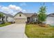 Charming single-Gathering home with well-maintained lawn and a two-car garage at 1825 Lotus Ln, Denver, NC 28037