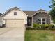 Charming single-story home featuring stone accents, a two-car garage, and a well-maintained front yard at 1825 Lotus Ln, Denver, NC 28037