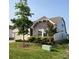 Single-Gathering home with light gray siding, stonework accents, a lush lawn, and mature landscaping at 1825 Lotus Ln, Denver, NC 28037
