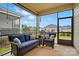 Comfortable screened porch with plush seating, offering a peaceful outdoor living space at 1825 Lotus Ln, Denver, NC 28037
