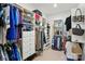 Spacious walk-in closet with custom shelving, drawers, and ample hanging space for organized storage at 1825 Lotus Ln, Denver, NC 28037