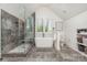Luxurious bathroom featuring a glass-enclosed shower, soaking tub, and modern fixtures at 1830 Wickford Pl, Charlotte, NC 28203