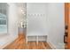 Bright entryway with hardwood floors, built-in bench, and view into the modern kitchen at 1830 Wickford Pl, Charlotte, NC 28203
