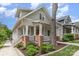 Charming two-story home with gray siding, brick accents, and a welcoming front porch at 1830 Wickford Pl, Charlotte, NC 28203