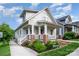 Inviting front porch showcasing classic columns and a well-maintained garden, enhancing curb appeal at 1830 Wickford Pl, Charlotte, NC 28203
