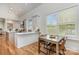 Modern kitchen with white cabinets, stainless steel appliances, a center island, and an eat-in area at 1830 Wickford Pl, Charlotte, NC 28203