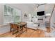 Open-concept living room features fireplace, built-ins, and picture windows at 1830 Wickford Pl, Charlotte, NC 28203
