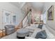 Open concept living room with hardwood floors, staircase, and view into the kitchen at 1830 Wickford Pl, Charlotte, NC 28203