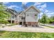 View of home's rear exterior; charming home with a lovely deck and well-maintained landscaping at 1830 Wickford Pl, Charlotte, NC 28203