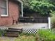 Cozy wooden backyard deck with wrought iron furniture, offering a relaxing outdoor space for entertaining and enjoying the scenery at 2009 Hickory Grove Rd, Gastonia, NC 28056
