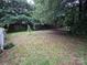 Expansive backyard featuring mature trees and a privacy fence, creating a serene outdoor space at 2009 Hickory Grove Rd, Gastonia, NC 28056