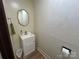 Half-bathroom featuring a simple vanity and framed mirror at 2009 Hickory Grove Rd, Gastonia, NC 28056