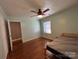 Charming bedroom with wood floors, a ceiling fan, and ample natural light from window and closet at 2009 Hickory Grove Rd, Gastonia, NC 28056