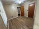 Bright bedroom features wood-look flooring, classic paneling, and a ceiling fan with natural light at 2009 Hickory Grove Rd, Gastonia, NC 28056